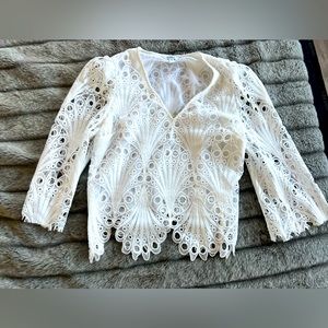 Women’s blouse in white. Never worn. Beautiful design and texture.